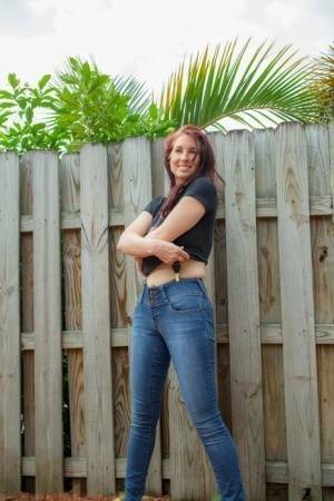 Hot redhead Andy Adams loses her t-shirt & jeans in the yard to pose naked - #1