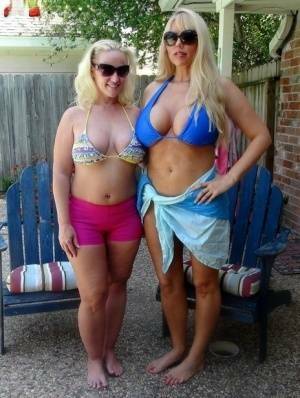 Blonde chicks Karen Fisher and Dee Siren loose their big tits from bikini tops on girlsabc.com