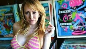 Brett Rossi fingers her pussy in striped OTK socks atop pinball machine on girlsabc.com
