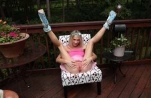 Thin blonde Sky Pierce attaches clamps to her wide open pussy on a deck on girlsabc.com
